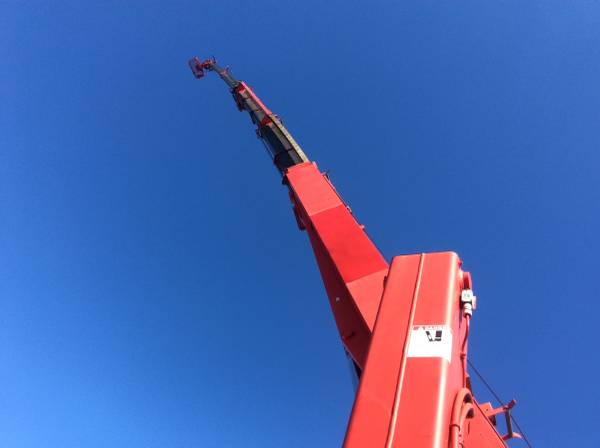 Sign Store employee on crane installing sign